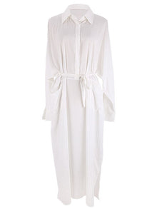 Woman wearing a white maxi beach dress kaftan as a swimsuit cover-up, perfect for summer beach and pool outings.