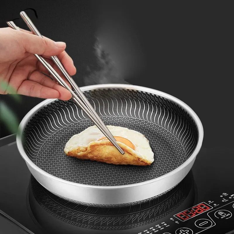 Tri-ply stainless steel double-sided nonstick frying pan with ergonomic handle for easy flipping


