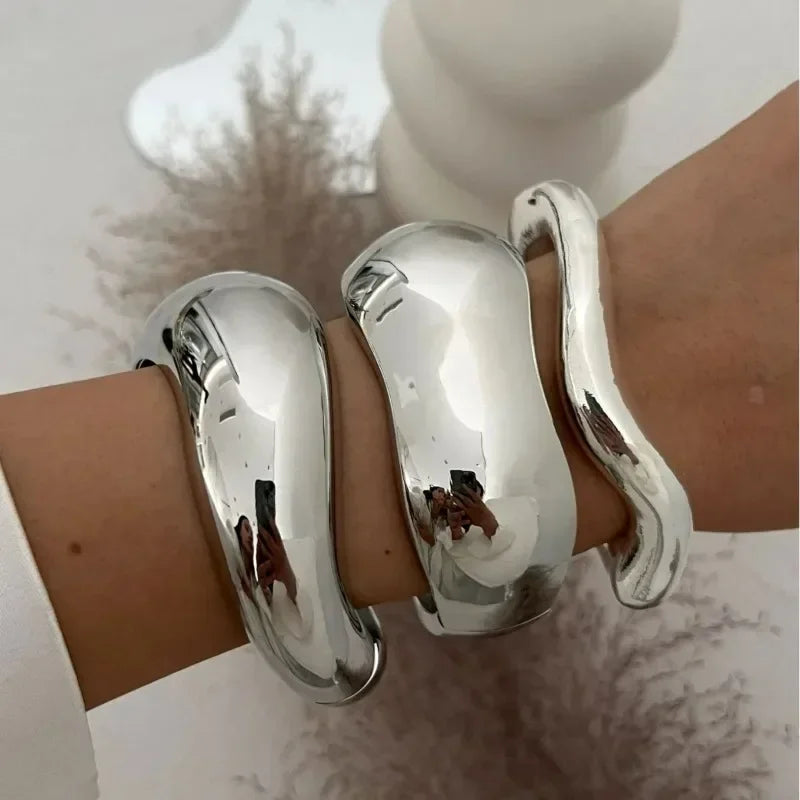 Wide cuff bangles in gold and silver with geometric design