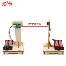 Child building DIY infrared alarm STEM kit on table